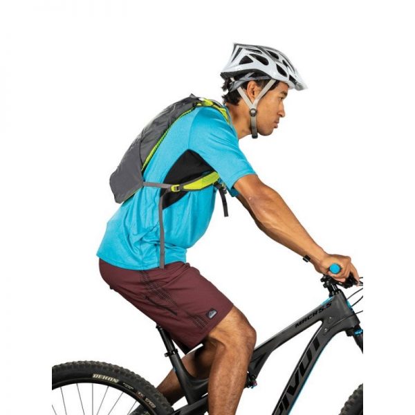 Man on a bike carrying Osprey Katari 3 Hydration Pack Limestone